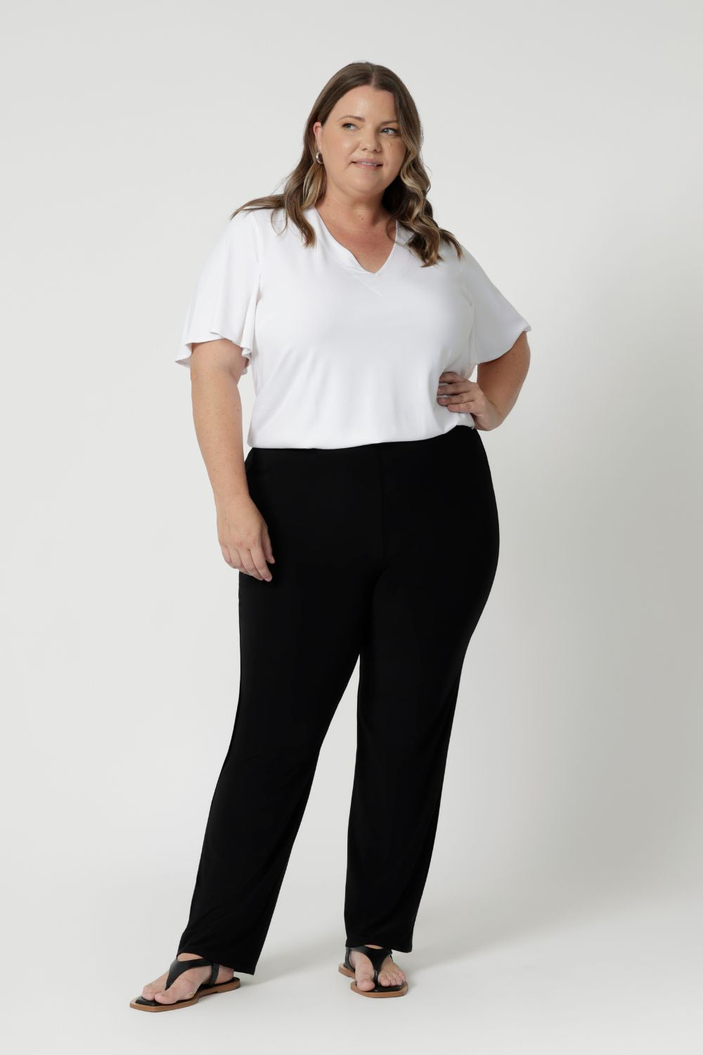 Plus sized model wears casual black pants  Whether you're at the office or on the go, these pants will keep you looking polished and feeling comfortable all day long. Leina & Fleur consider many different sizes when developing their clothes and proudly stock 8-24.