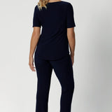 Size 12 woman wears navy workwear pants with matching navy top and a nude heel for a classic yet comfortable workwear look. Leina & Fleur stocks these pants in sizes 8-24.