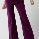 Close up of a size 10 woman wears the Jonas pant in Magenta Velveteen with a kick flare. The perfect cocktail suit set. Made in Australia for women size 8 - 24. Styled back with the Eddy Cami in Twilight.