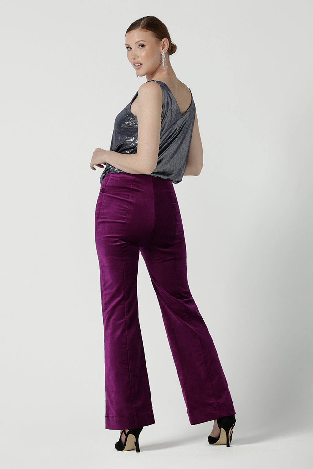 Back view of a size 10 woman wears the Jonas pant in Magenta Velveteen with a kick flare. The perfect cocktail suit set. Made in Australia for women size 8 - 24. Styled back with the Eddy Cami in Twilight.