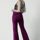 Back view of a size 10 woman wears the Jonas pant in Magenta Velveteen with a kick flare. The perfect cocktail suit set. Made in Australia for women size 8 - 24. Styled back with the Eddy Cami in Twilight.