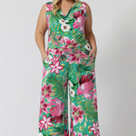 Plus sized model wears Joni Top paired with Dany Culotte in the same floral print featuring a teal-blue slinky jersey base with print details in shades of green, pink, white, yellow and brown. The fabric has a soft stretch and breathable feel. Proudly stocked in sizes 8-24 by fashion brand Leina & Fleur.