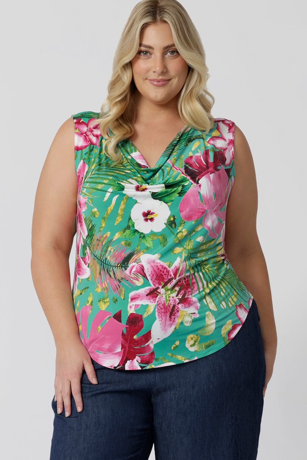Plus sized woman wears sleeveless top in floral Malibu print. Made in Australia in sizes 8-24. Whether you're dressing up for a casual day out or a more formal summer occasion, this top is an effortless, stylish addition to your warm-weather wardrobe.