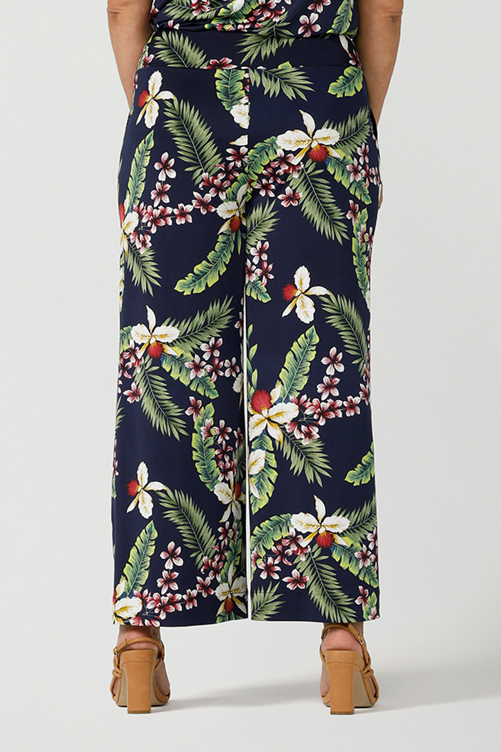 Back view close up of a size 12 woman wears wide leg Dany culotte in Merriment print. The perfect Christmas pant to wear for the festive season. Made in Australia for sizes 8 - 24.