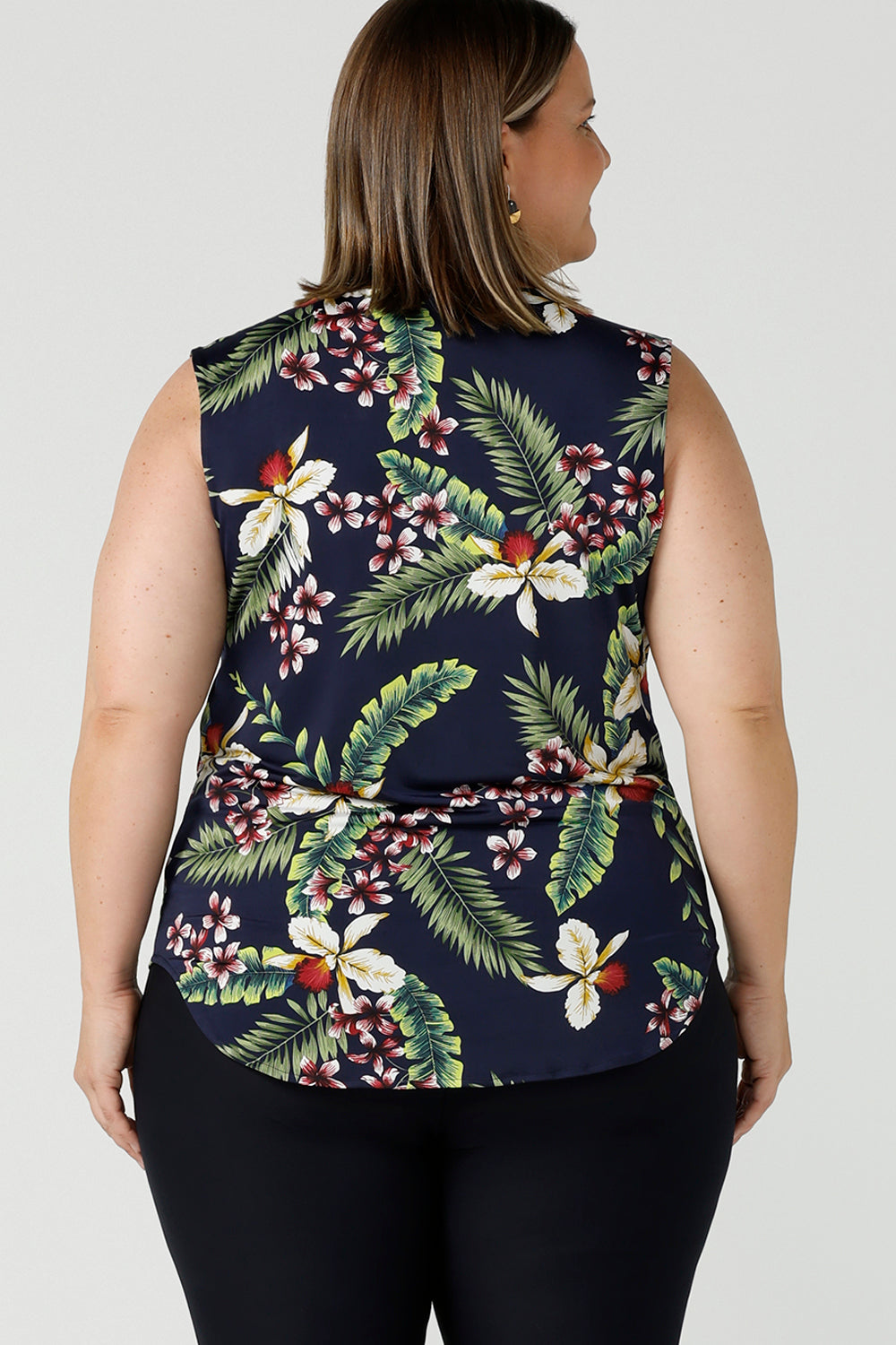 Back view of a curvy size 18 woman wears a Joni Top in Merriment print. The perfect top to wear for the Christmas festive season and on Christmas day. The top features a cowl neckline and soft stretch jersey material. Made in Australia for sizes 8-24.