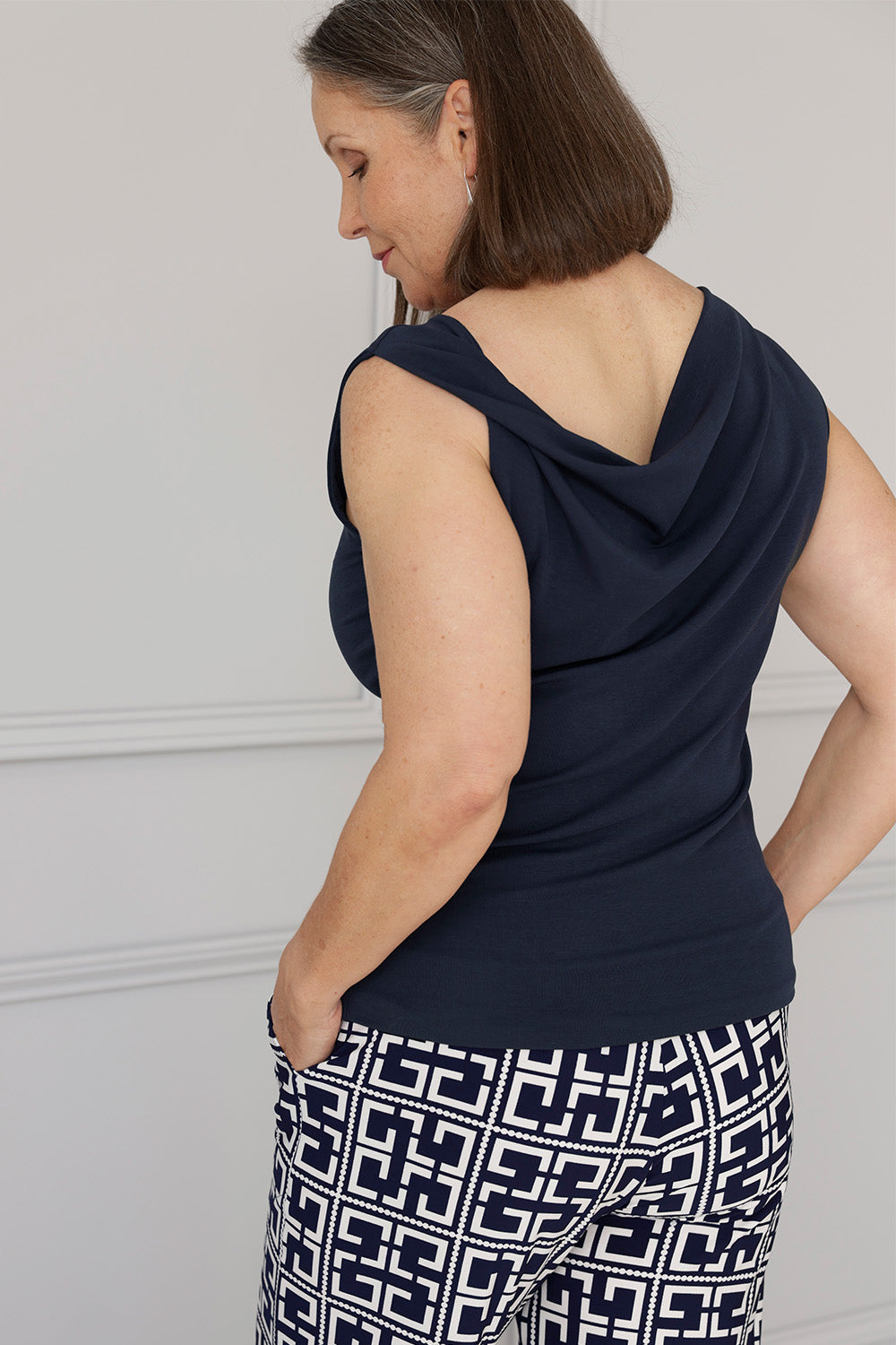 Reversible design gives you two sophisticated looks in one, wear it with the asymmetrical cowl neckline and twisted shoulder detail at the front, or reverse it for a clean boat-neckline with soft draping at the back. Available in sizes 8-24.