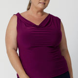 The twisted shoulder detail adds a subtle yet striking touch, elevating the design with a unique, contemporary flair. Plus size woman wears her Jordan top paired back with navy skirt.