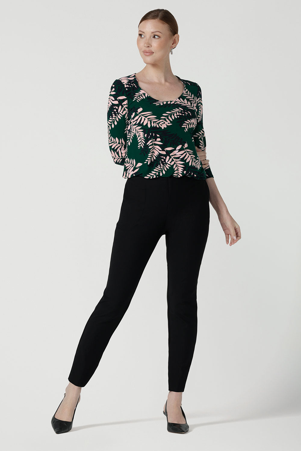 The Jules top in alpine is a green leaf printed top with a scoop neckline. Jersey top with 3/4 sleeves. Made in Australia for women size. 8 - 24. Styled back with black brooklyn pants.