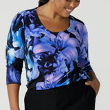 Size 16 woman wears the Jules top in Blue Lily. A Scoop neck style we a 3/4 sleeve. Digitally printed with a blue Lily Print. Size inclusive fashion, made in Australia for women size 8 - 24.