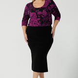 Size 18 woman wears the Jules top in Fuchsia Flora with a scoop neckline and 3/4 sleeves. Comfortable and easy care jersey fabric perfect for work to dinner style. Made in Australia for women size 8 - 24.