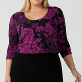 Size 18 woman wears the Jules top in Fuchsia Flora with a scoop neckline and 3/4 sleeves. Comfortable and easy care jersey fabric perfect for work to dinner style. Made in Australia for women size 8 - 24. 