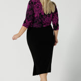 Back view of a size 18 woman wears the Jules top in Fuchsia Flora with a scoop neckline and 3/4 sleeves. Comfortable and easy care jersey fabric perfect for work to dinner style. Made in Australia for women size 8 - 24.