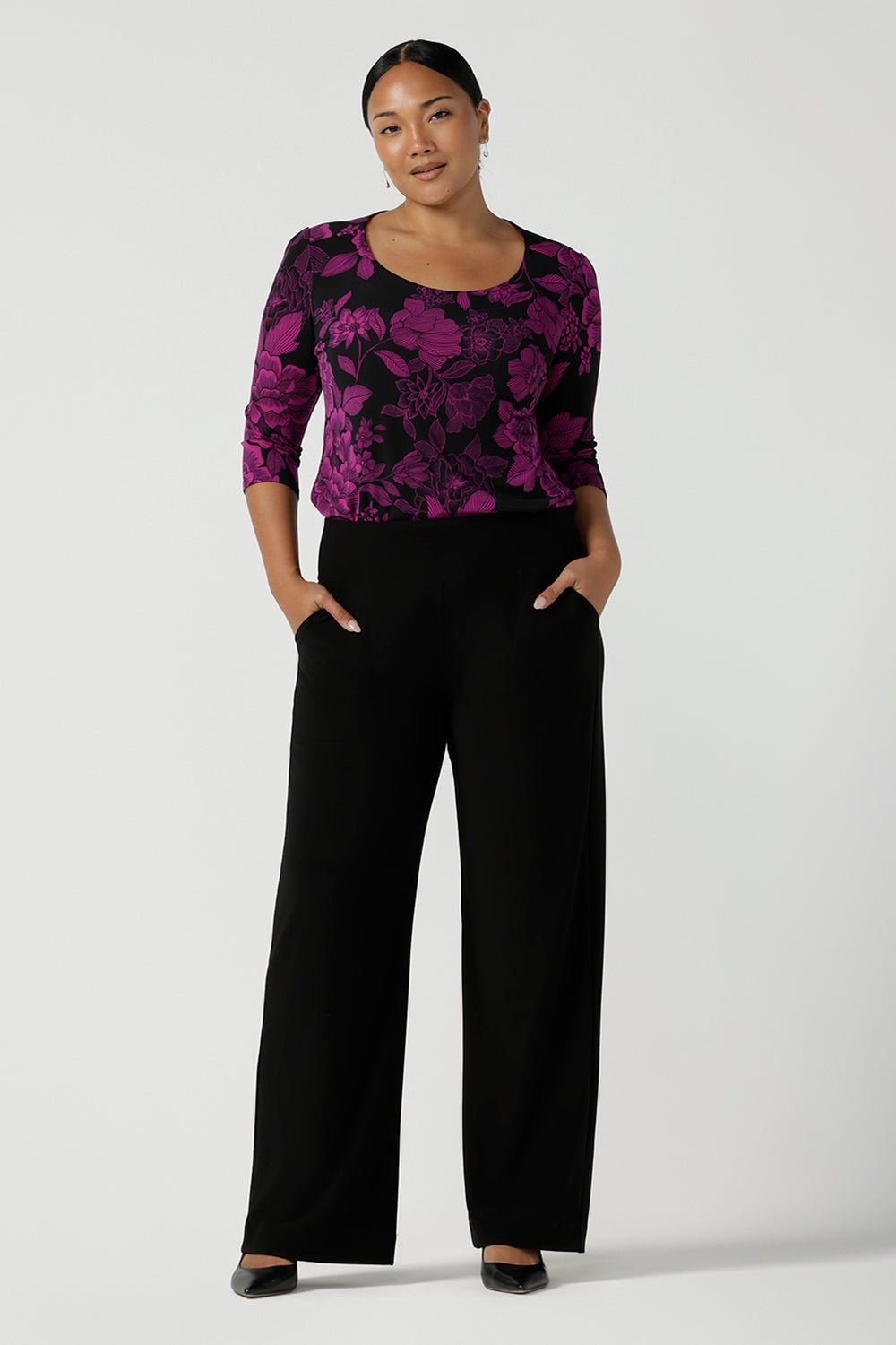 Size 10 woman wears the Jules top in Fuchsia Flora with a scoop neckline and 3/4 sleeves. Comfortable and easy care jersey fabric perfect for work to dinner style. Made in Australia for women size 8 - 24.