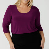 A size 18 woman wears the Jules top in Magenta. A soft jersey easy care 3/4 sleeve top ion rich purple magenta colour. Scoop neckline and made in Australia for women size 8 - 24. 