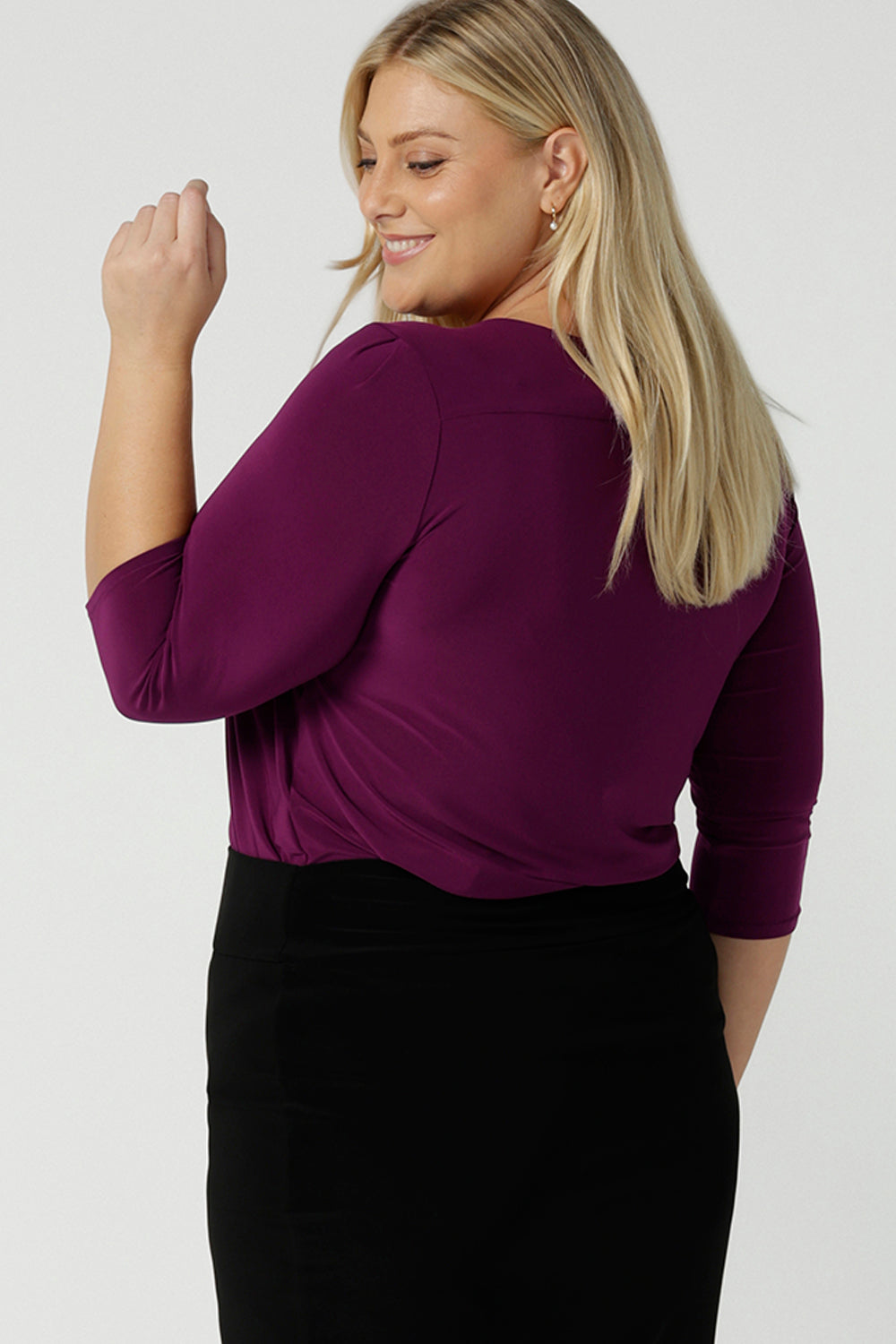 Back view of a size 18 woman wears the Jules top in Magenta. A soft jersey easy care 3/4 sleeve top ion rich purple magenta colour. Scoop neckline and made in Australia for women size 8 - 24.