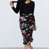 Size 10 woman wears the Andi tube skirt in Boronia, a slim fit midi skirt with Boronia matisse inspired print. Styled back with the Thom top n black and black pump heels. Made in Australia for women size 8 to 24. 