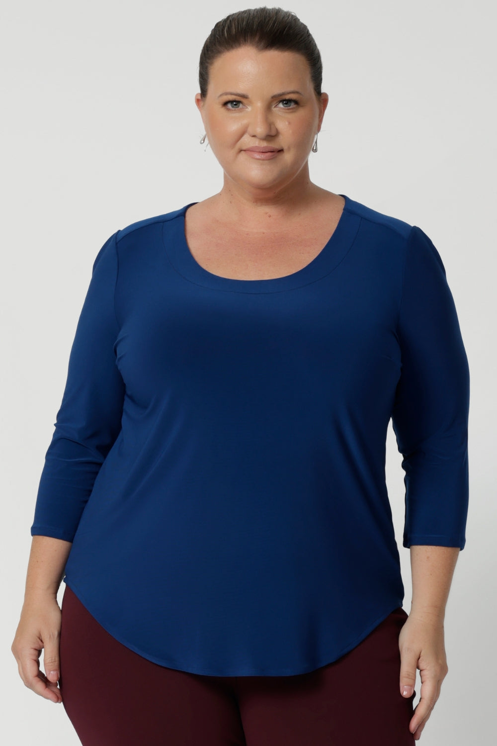 The shirttail hemline makes the Jules Top versatile—whether tucked into work trousers or skirts for a professional look. Woman's workwear top is made with blue coloured dry touch jersey fabric that is easy care with wrinkle resistant properties. Available in sizes 8-24.