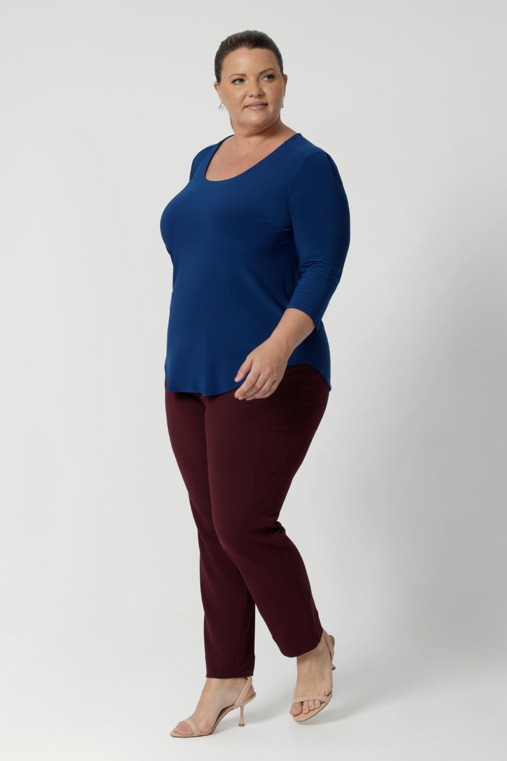 Workwear top pairs effortlessly with our Blazers, making it an essential piece for any corporate wardrobe. Whether dressing for the office or a weekend outing, the Jules Top provides the perfect balance of style, comfort, and versatility. Plus size model wears basic top with tapered leg pants to create simple yet elegant outfit.