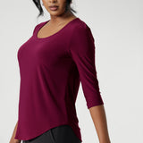 The semi-fitted silhouette creates a flattering shape, while the round neckline with a topstitched facing adds a clean, refined look. The 3/4 sleeves, with tucks at the sleeveheads, bring a touch of elegance, and the back shoulder yoke with a central pleat below provides a relaxed yet structured feel