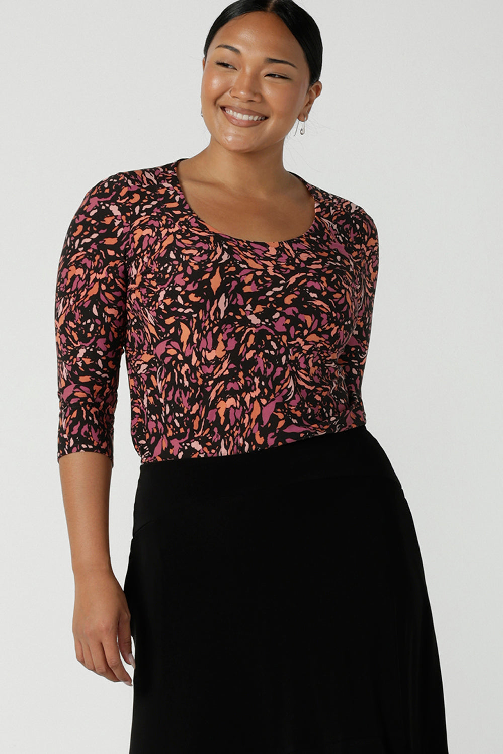  A size 10 woman wears the Jules Top in Terrazzo, a scoop neckline style with 3/4 sleeves. A comfortable easy care jersey style made in Australia for women size 8 - 24. 