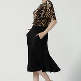 Back view of a size 10 woman wears the Juniper top in Gold Leopard. A flutter sleeve jersey top with flutter sleeves. Leina & Fleur are an Australian made fashion label on the Gold Coast Australia. Offering Petite to Plus size fashion 8 - 24. Comfortable workwear for women.