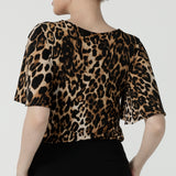 Back view of a size 10 woman wears the Juniper top in Gold Leopard. A flutter sleeve jersey top with flutter sleeves. Leina & Fleur are an Australian made fashion label on the Gold Coast Australia. Offering Petite to Plus size fashion 8 - 24. Comfortable workwear for women. 