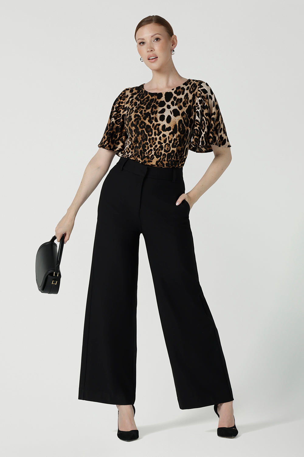 A size 10 woman wears the Juniper top in Gold Leopard. A flutter sleeve jersey top with flutter sleeves. Leina & Fleur are an Australian made fashion label on the Gold Coast Australia. Offering Petite to Plus size fashion 8 - 24. Comfortable workwear for women.