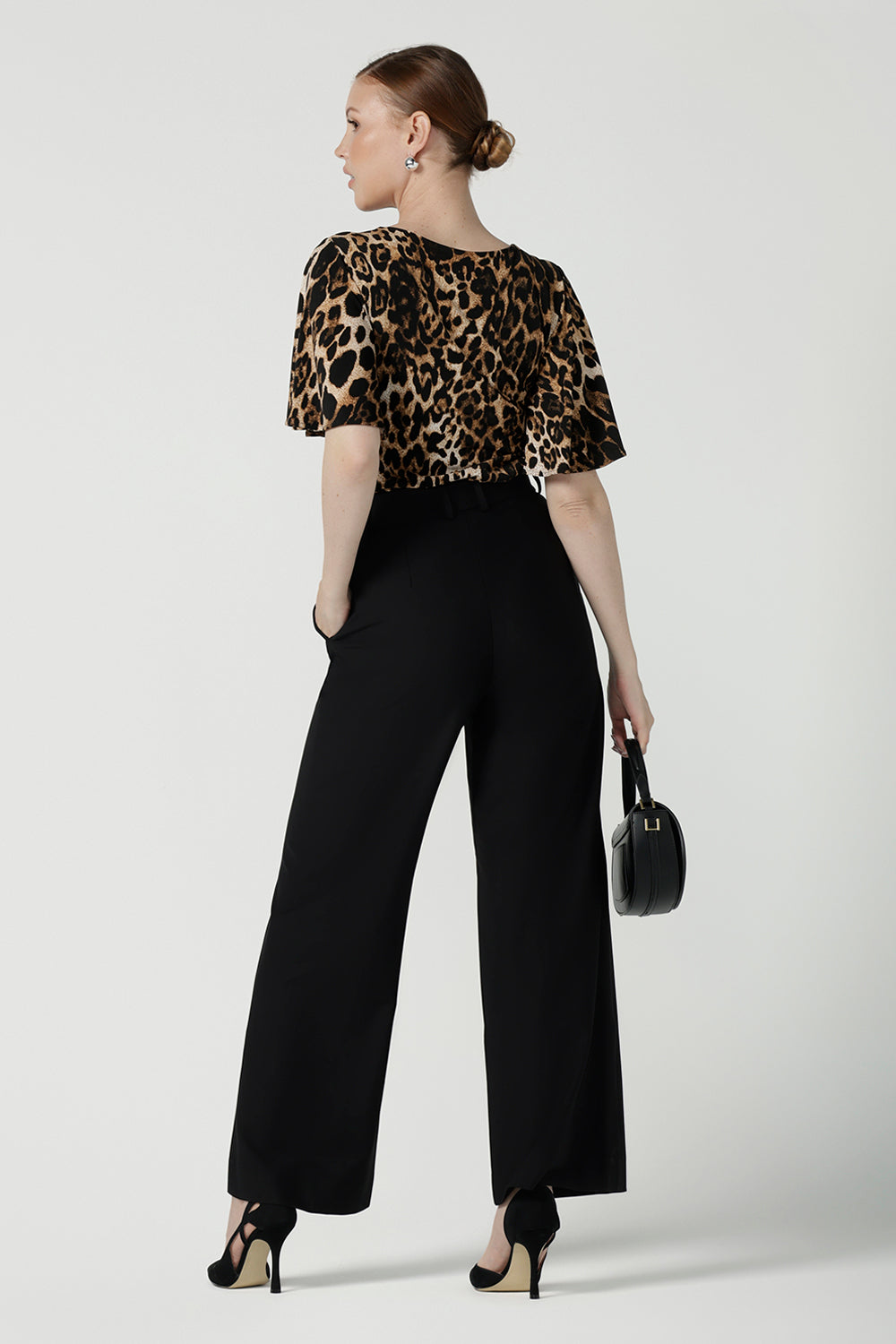 Back view of a size 10 woman wears the Juniper top in Gold Leopard. A flutter sleeve jersey top with flutter sleeves. Leina & Fleur are an Australian made fashion label on the Gold Coast Australia. Offering Petite to Plus size fashion 8 - 24. Comfortable workwear for women.