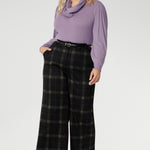 Designed to move with you, this collection offers refined silhouettes that transition effortlessly from work to smart-casual settings. Plus size woman wears her Kade wide leg pants with Lilac coloured top and scarf & black kitten heels.