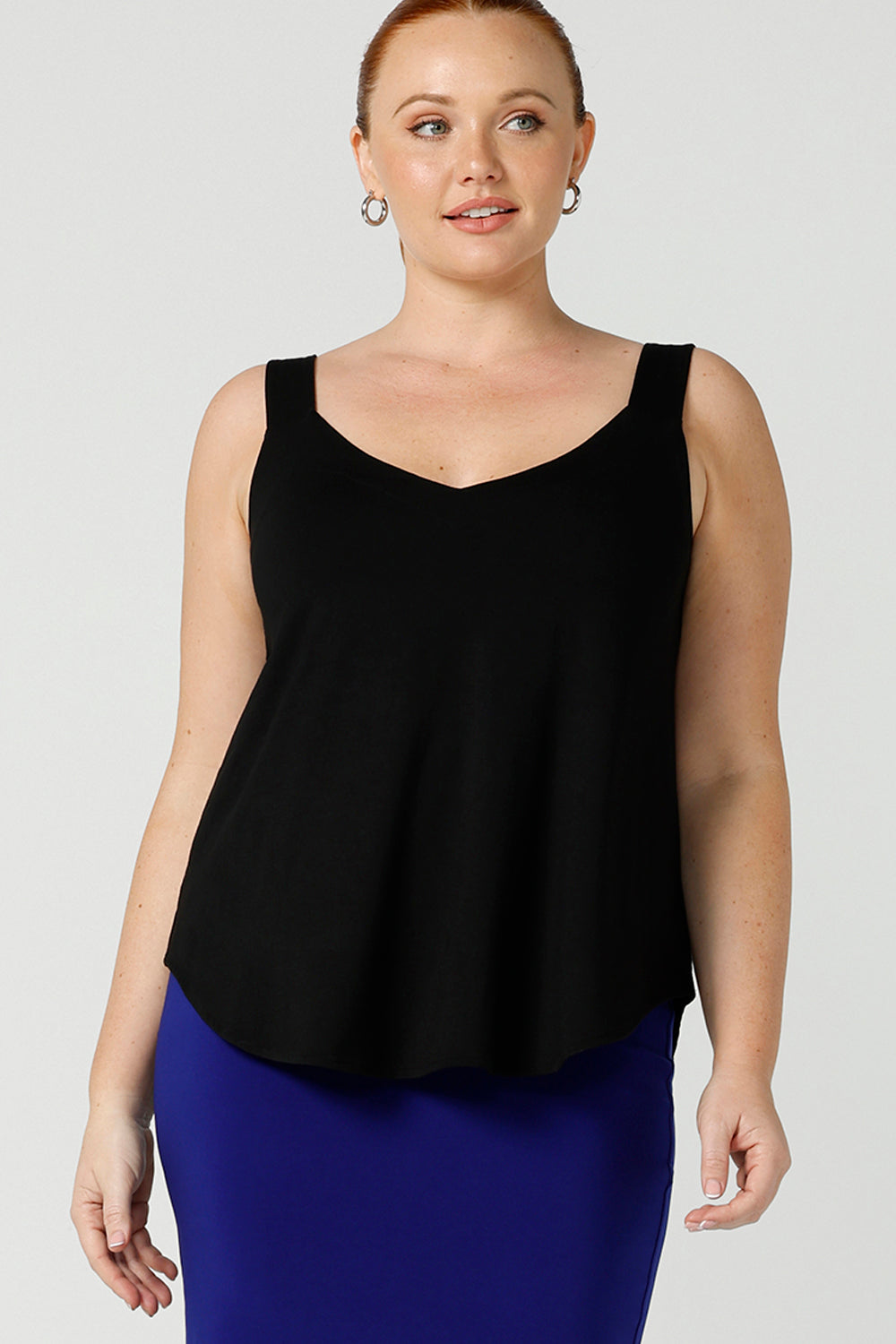 a size 12, curvy woman wears a bamboo cami. In black bamboo jersey, this top is a good addition to your capsule wardrobe for weekend wear, work and travel. Shop Australian-made dresses online is sizes 8 to 24.