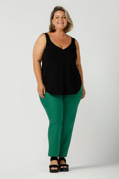 a size 18, fuller figure woman wears a bamboo cami with emerald green tailored pants. In black bamboo jersey, this top is a good addition to your capsule wardrobe for weekend wear, work and travel. Shop Australian-made dresses online is sizes 8 to 24.