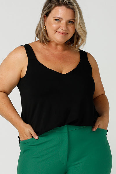 Close up of a size 18, fuller figure woman wears a bamboo cami. In black bamboo jersey, this top is a good addition to your capsule wardrobe for weekend wear, work and travel. Shop Australian-made dresses online is sizes 8 to 24.