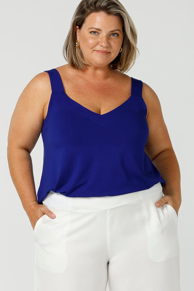 a plus size 18, curvy woman wears a bamboo cami. In cobalt blue bamboo jersey, this top is a good addition to your capsule wardrobe for weekend wear, work and travel. Shop Australian-made dresses online is sizes 8 to 24.