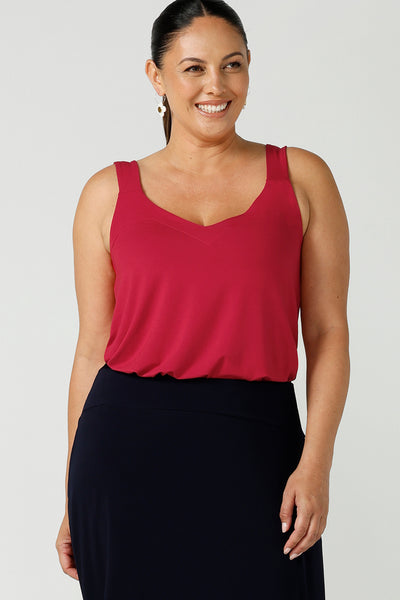 A size 12 Happy woman wears a bamboo cami top in red. Bamboo material is breathable and temperature regulating. A great work to weekend top for the Christmas season. Made in Australia for women size 8 - 24.
