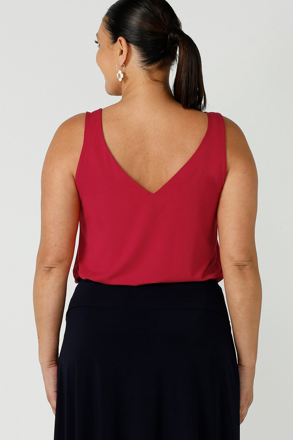 Back view of a size 12 happy woman wears a bamboo cami top in red. Bamboo material is breathable and temperature regulating. A great work to weekend top for the Christmas season. Made in Australia for women size 8 - 24.