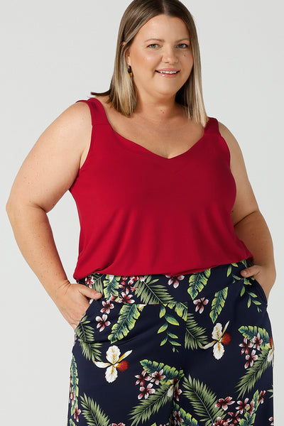 A curvy size 18 happy woman wears a red bamboo Kai cami top. Breathable bamboo material is breathable and temperature regulating. Made in Australia for women sizes 8 - 24. 