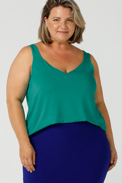 Close up of a plus size 18, curvy woman wears a bamboo cami. In jade green bamboo jersey, this top is a good addition to your capsule wardrobe for weekend wear, work and travel. Shop Australian-made dresses online is sizes 8 to 24.