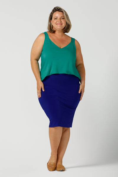 a plus size 18, curvy woman wears a bamboo cami with a cobalt blue tube skirt. In jade green bamboo jersey, this top is a good addition to your capsule wardrobe for weekend wear, work and travel. Shop Australian-made dresses online is sizes 8 to 24.
