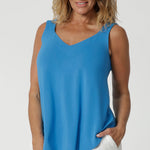 This women's summer cami is a perfect blend of elegance and functionality, crafted from luxurious, high-quality bamboo fabric in an opal colour. Its sleek, sleeveless design makes it an ideal choice for warm weather, offering a breezy and flattering fit. The top features a graceful V-neckline both in the front and the back, adding a touch of sophistication and subtle femininity to the overall look. Available in sizes 8-24.