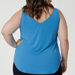 Size 18 woman wears summer ready cami in opal colour. Ideal choice for warm weather, offering a breezy and flattering fit. The top features a graceful V-neckline both in the front and the back, adding a touch of sophistication and subtle femininity to the overall look.