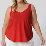 This summer cami in a vibrant tangerine colour is the ultimate blend of style, comfort, and function—perfect for those warm-weather getaways or sunny days at home. Made from a luxuriously soft bamboo jersey fabric, it offers a breathable feel that keeps you cool and comfortable all day long. The fabric’s thermoregulating properties help maintain the perfect body temperature, whether you're strolling through a sun-drenched city or relaxing in the shade.