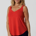 Over 40 woman wears soft bamboo jersey made cami. It offers a lightweight, breathable feel that keeps you cool and comfortable all day long. The fabric’s thermoregulating properties help maintain the perfect body temperature, whether you're strolling through a sun-drenched city or relaxing in the shade. Leina & Fleur proudly stock this Cami in 8-24.