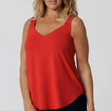 Over 40 woman wears soft bamboo jersey made cami. It offers a lightweight, breathable feel that keeps you cool and comfortable all day long. The fabric’s thermoregulating properties help maintain the perfect body temperature, whether you're strolling through a sun-drenched city or relaxing in the shade. Leina & Fleur proudly stock this Cami in 8-24.