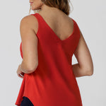 Kai Cami in Tangerine Bamboo can be seen featuring flattering V-shaped neckline both in the front and back, adding a touch of feminine elegance while offering an easy, breezy fit. Its versatile design makes it an excellent travel companion, as it’s both stylish and practical for packing light. Sizes 8-24 available. 