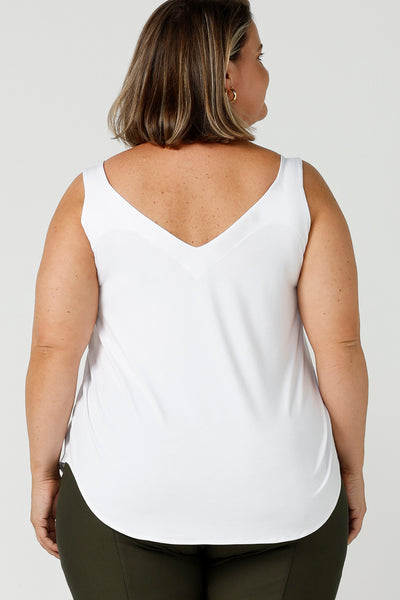 Back view of a plus size 18, fuller figure woman wears a bamboo cami. In white bamboo jersey, this top is a good addition to your capsule wardrobe for weekend wear, work and travel. Shop Australian-made dresses online is sizes 8 to 24.