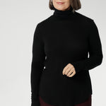This Black long-sleeve top is crafted from a luxurious blend of lightweight TENCEL™ and wool, offering breathable warmth without the bulk. The high turtleneck adds a cosy, refined touch, while built-in thumb holes provide extra coverage and comfort on cooler days.