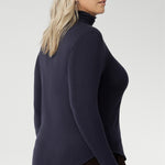 Introducing the Kean high turtleneck top from the Light Layers collection, a stylish and functional piece designed to elevate your wardrobe as the seasons cool. This long-sleeved top features convenient thumb holes for added comfort and warmth. Crafted from lightweight, warm tencel wool fabric.