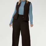 Made from a blend of stretchy Tencel wool fabric, it offers both flexibility and coziness, making it the perfect layering piece for cooler weather. Size 18 model wears her turtle neck top under her soft suiting, pairing her Pennyworth vest over the tencel wool top.