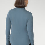 This long-sleeved top features convenient thumb holes for added comfort and warmth. Made from a blend of stretchy Tencel wool fabric, it offers both flexibility and coziness, making it the perfect layering piece for cooler weather.
