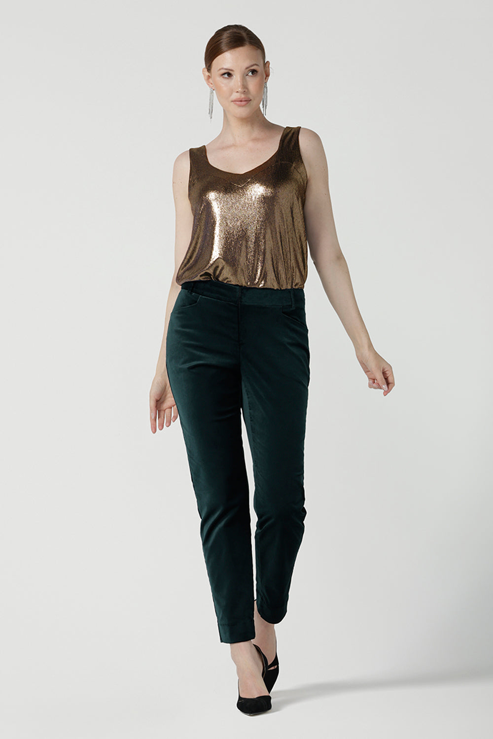 Front view of a size 10 woman wearing the Jonas Pant in green velveteen. A made in Australia velveteen pant styled back with the Eddy cami in Bullion Xanadu.